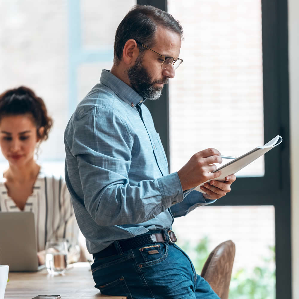 Man holding a list of questions to ask about networking